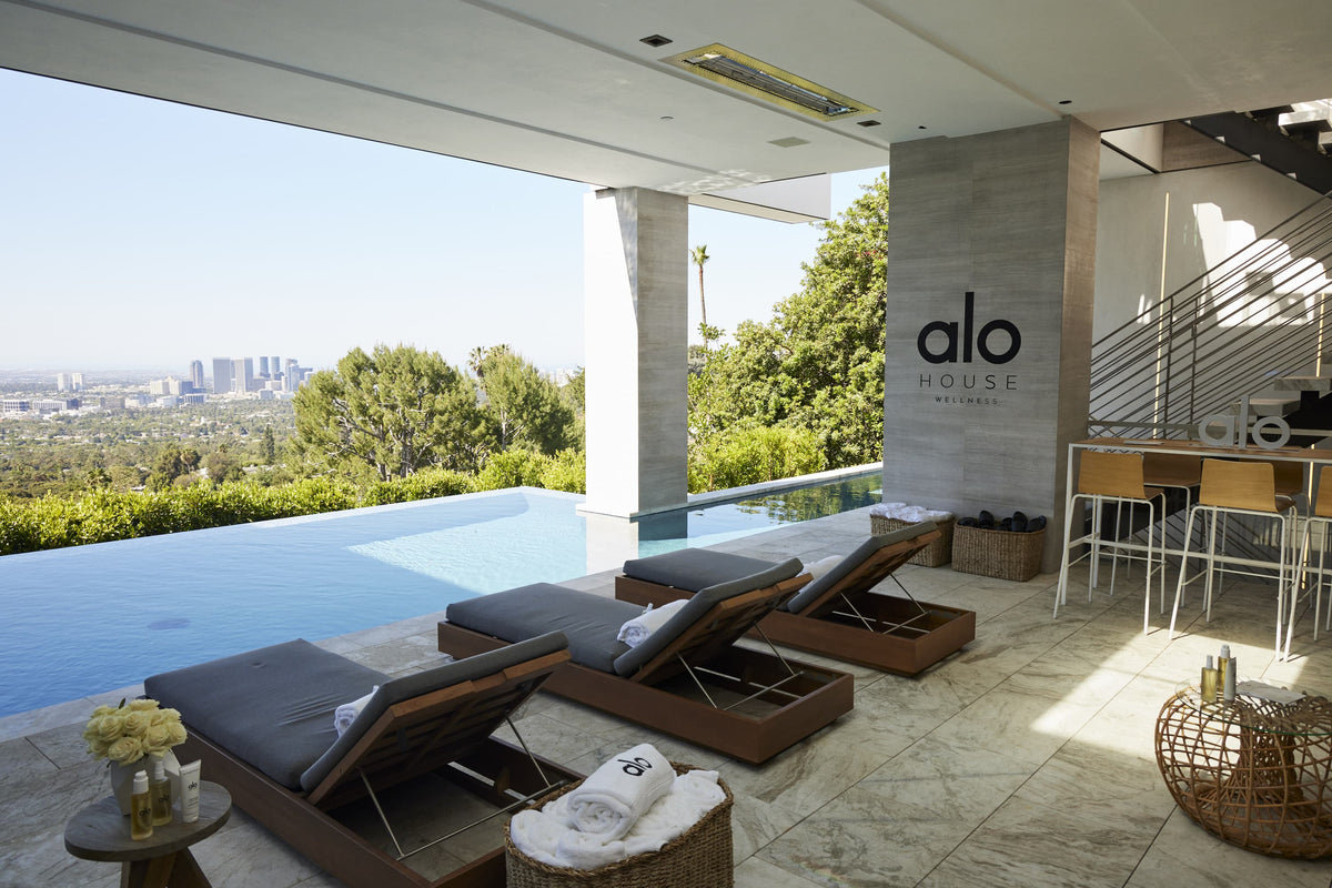 A photo of the pool and deck at Alo Wellness House.  