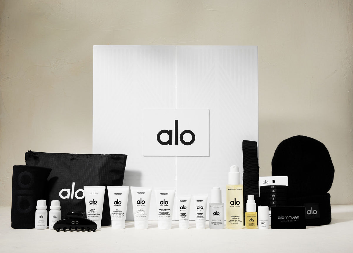Shot of a closed Alo advent calendar box with products lined up in front. 