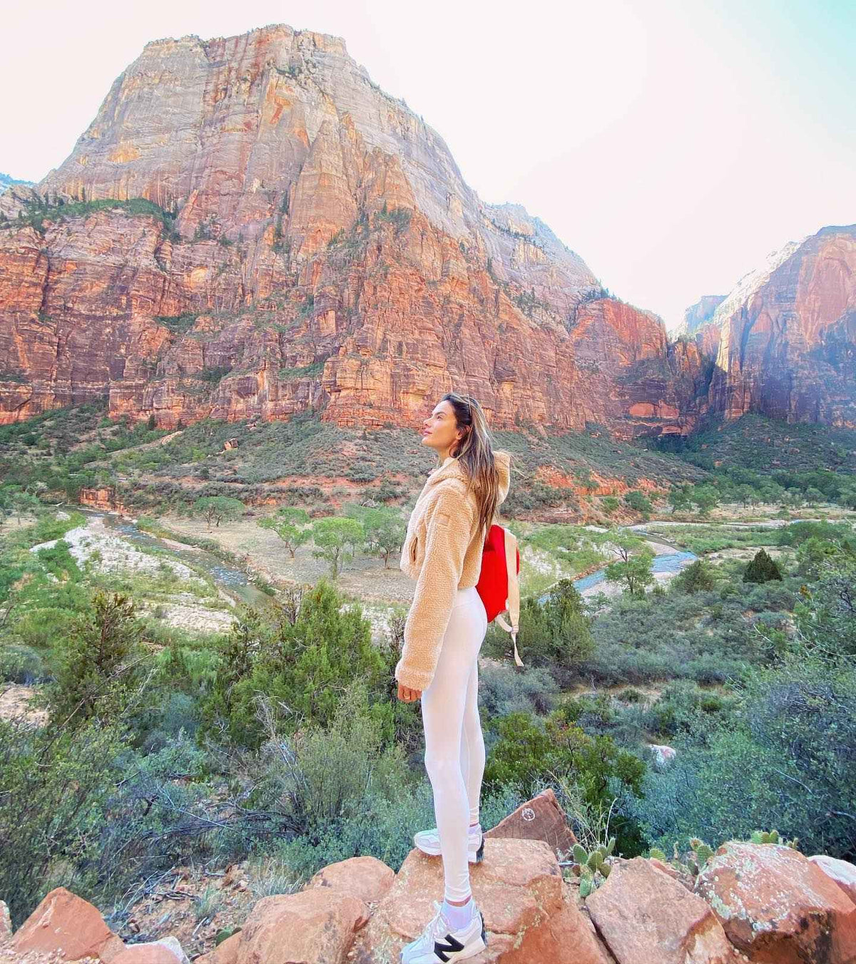 Alessandra Ambrosio wearing the LA Sherpa in Camel and White High Waist Airbrush Leggings while hiking through Zion National Park.  
